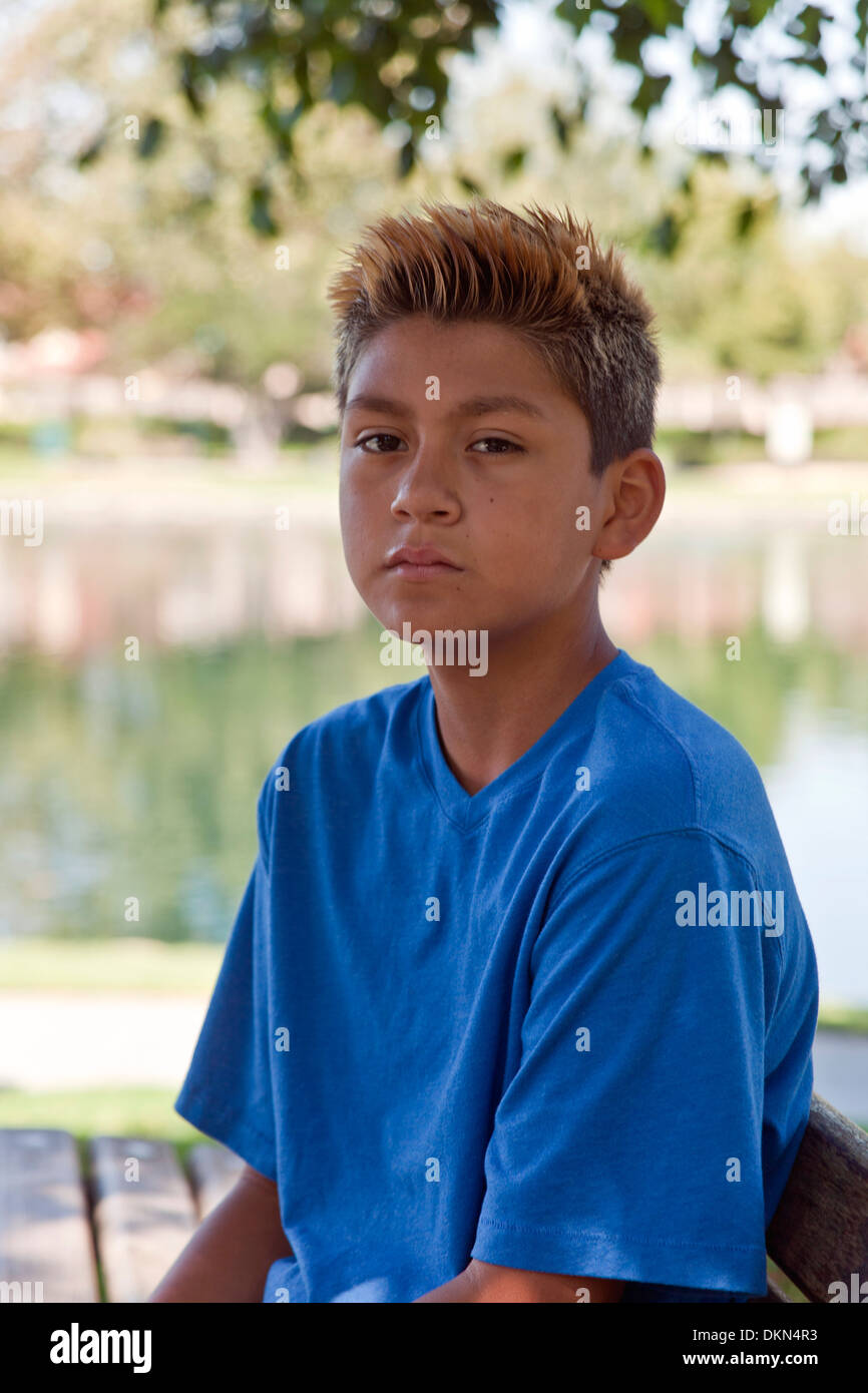 Trendy fashionable 11-13 year old Hispanic boy outside  multi racial diversity racially diverse multicultural cultural United States MR Stock Photo