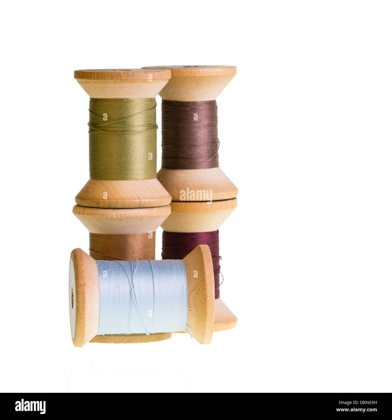 Wooden spools of sewing thread isolated on white Stock Photo