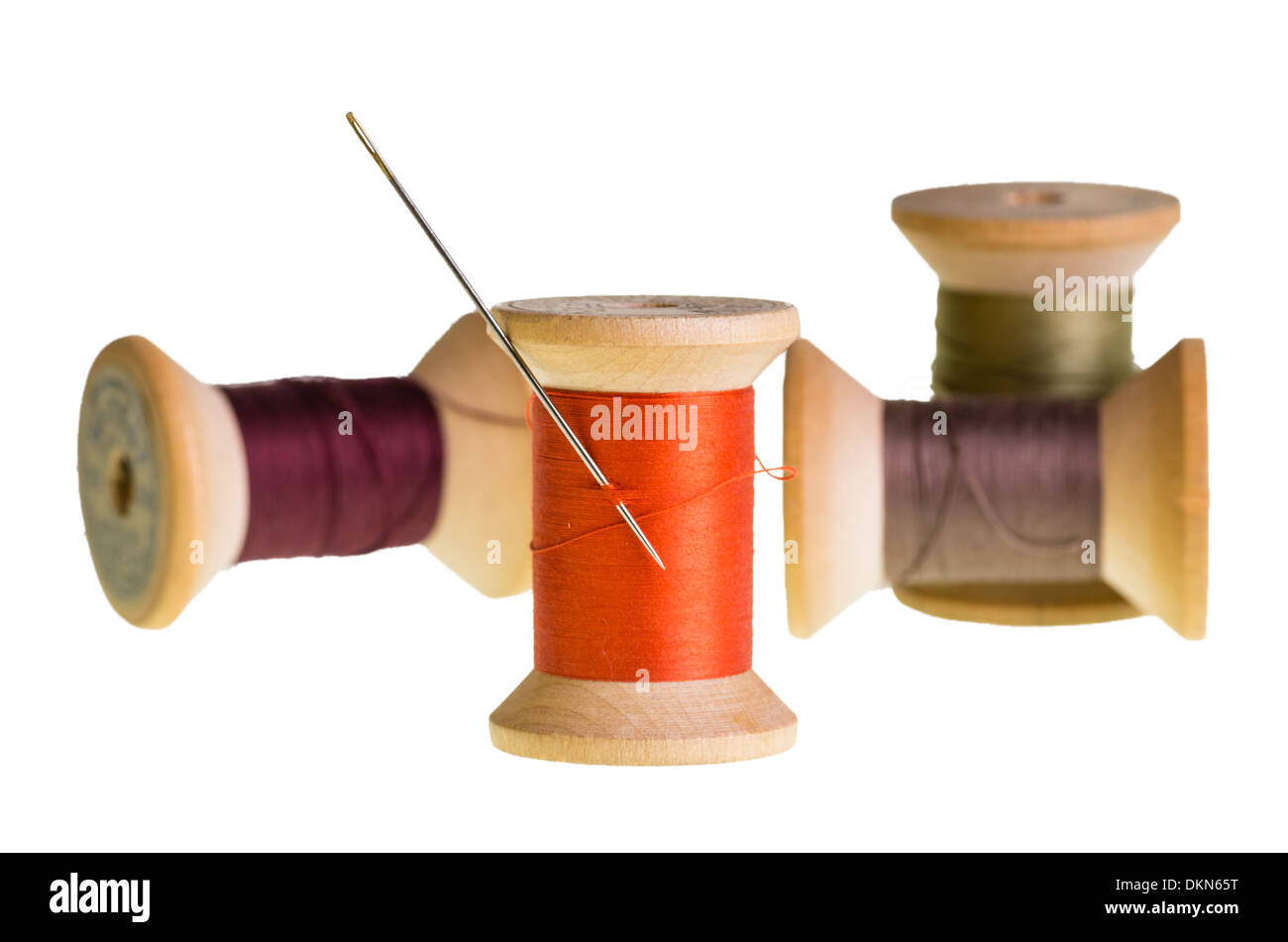 Spools of sewing thread with a needle Stock Photo Alamy