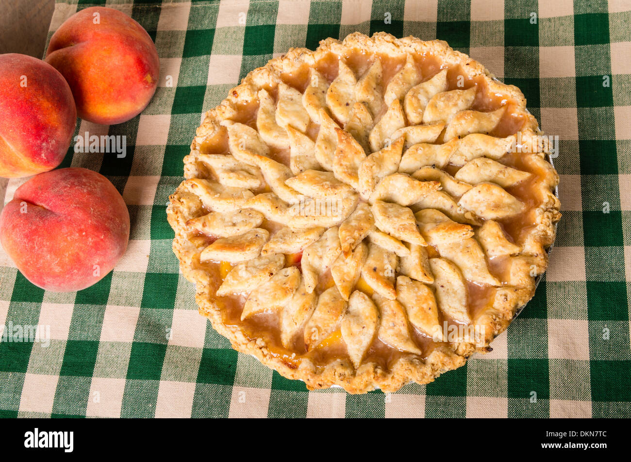 Peaches and peach pie with baked decorated crust Stock Photo Alamy