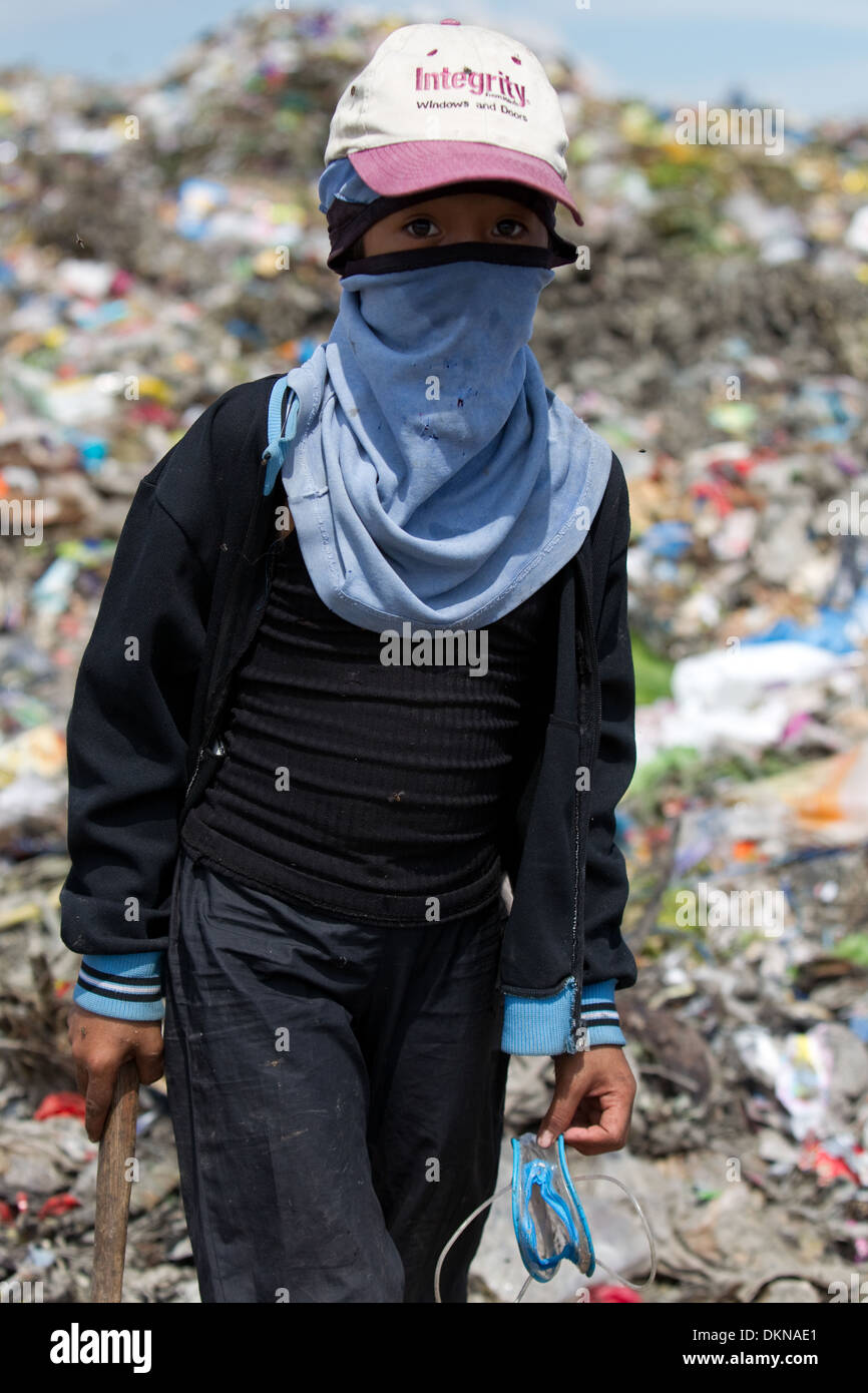 A child scavenging for anything of value within the Inayawan Landfill waste site,Cebu City,Philippines Stock Photo