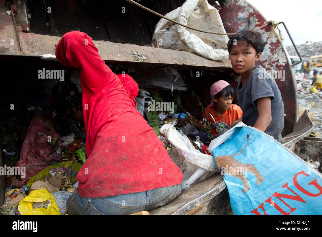 Children inside a dump truck,scavenging for anything of value within the Inayawan Landfill waste site,Cebu City,Philippines Stock Photo