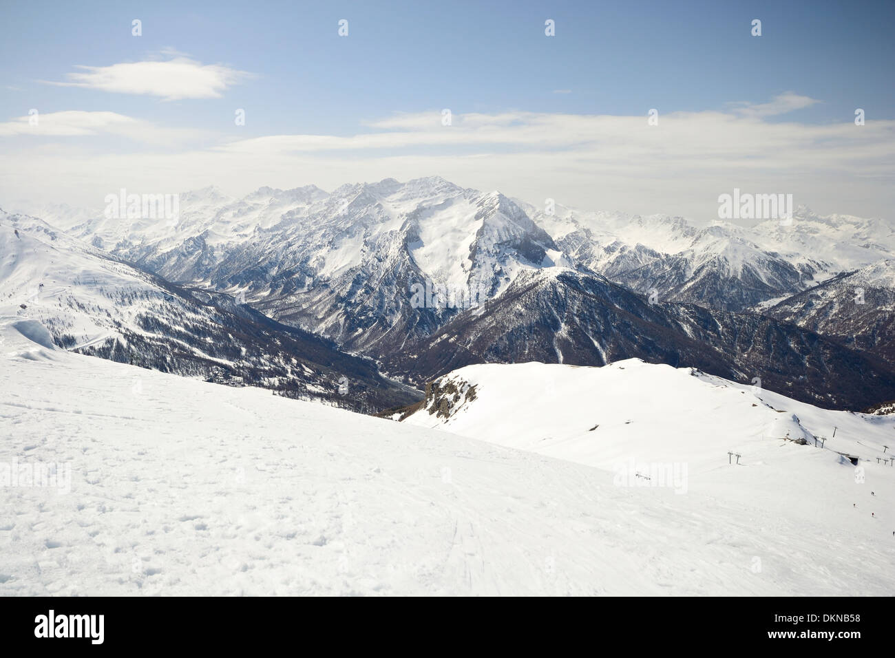 Off piste snowy slope in majestic high mountain frozen scenery and infinite view, winter in the italian Alps Stock Photo