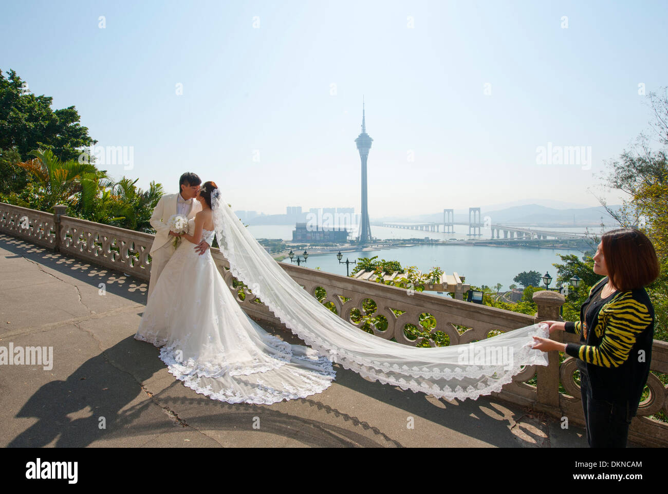 Photo shooting of a newly wed Chinese couple on Penha hill with view of Macau Tower, Macau, SAR of China Stock Photo