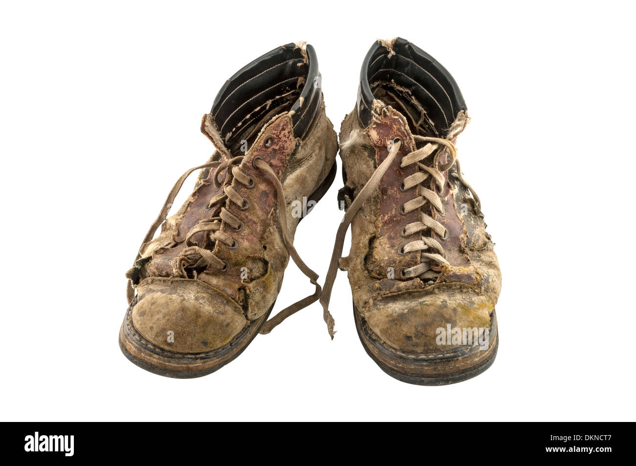 A pair of old dirty boots isolated on white background Stock Photo - Alamy