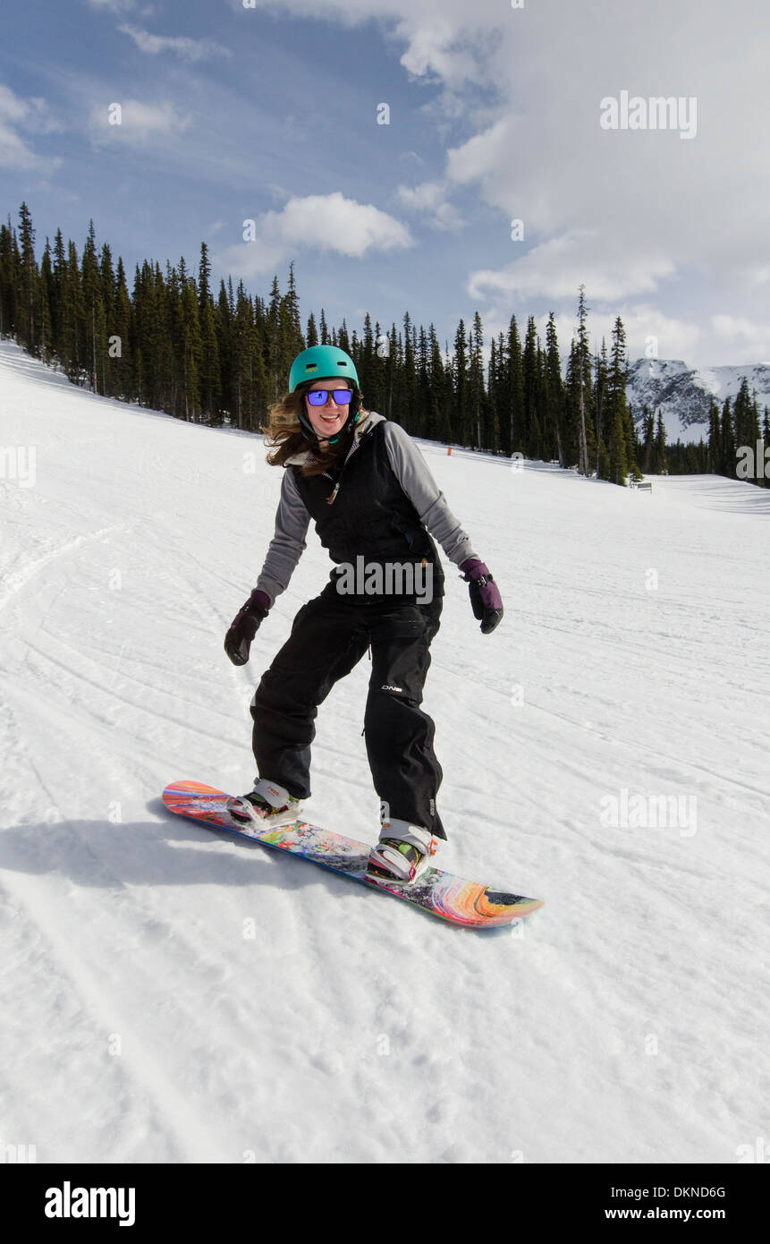 A young woman snowboarding at sunshine, Banff National Park, Canadian