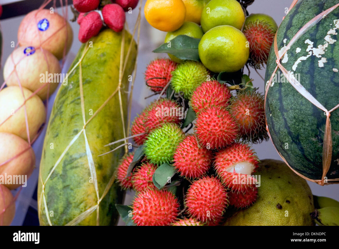 Fruit, including rambutan (center) and watermelon (right) is for sale at a food market in Battambang, Cambodia. Stock Photo