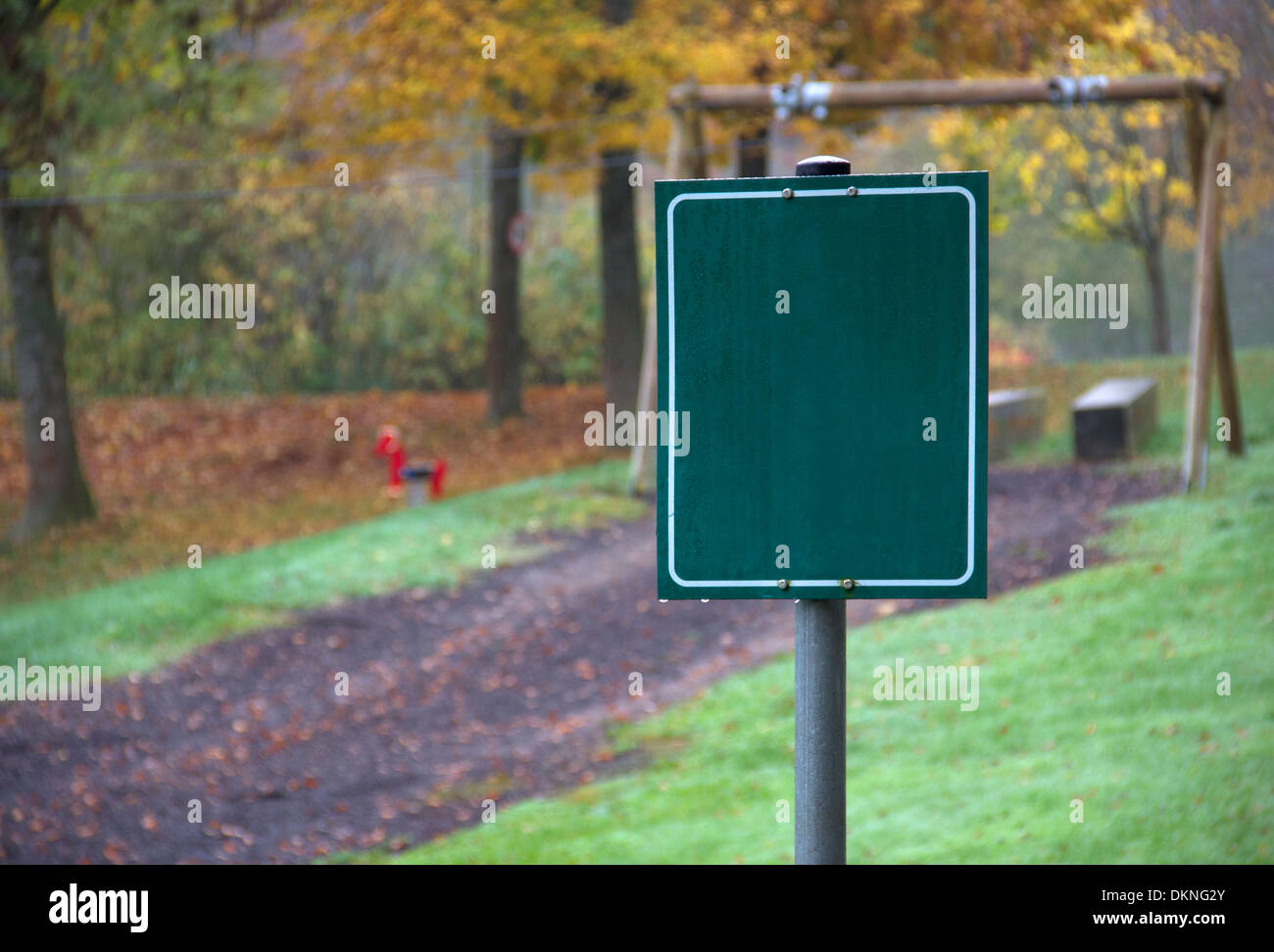 rural autumn scenery at a playground with blank green sign in Southern Germany Stock Photo