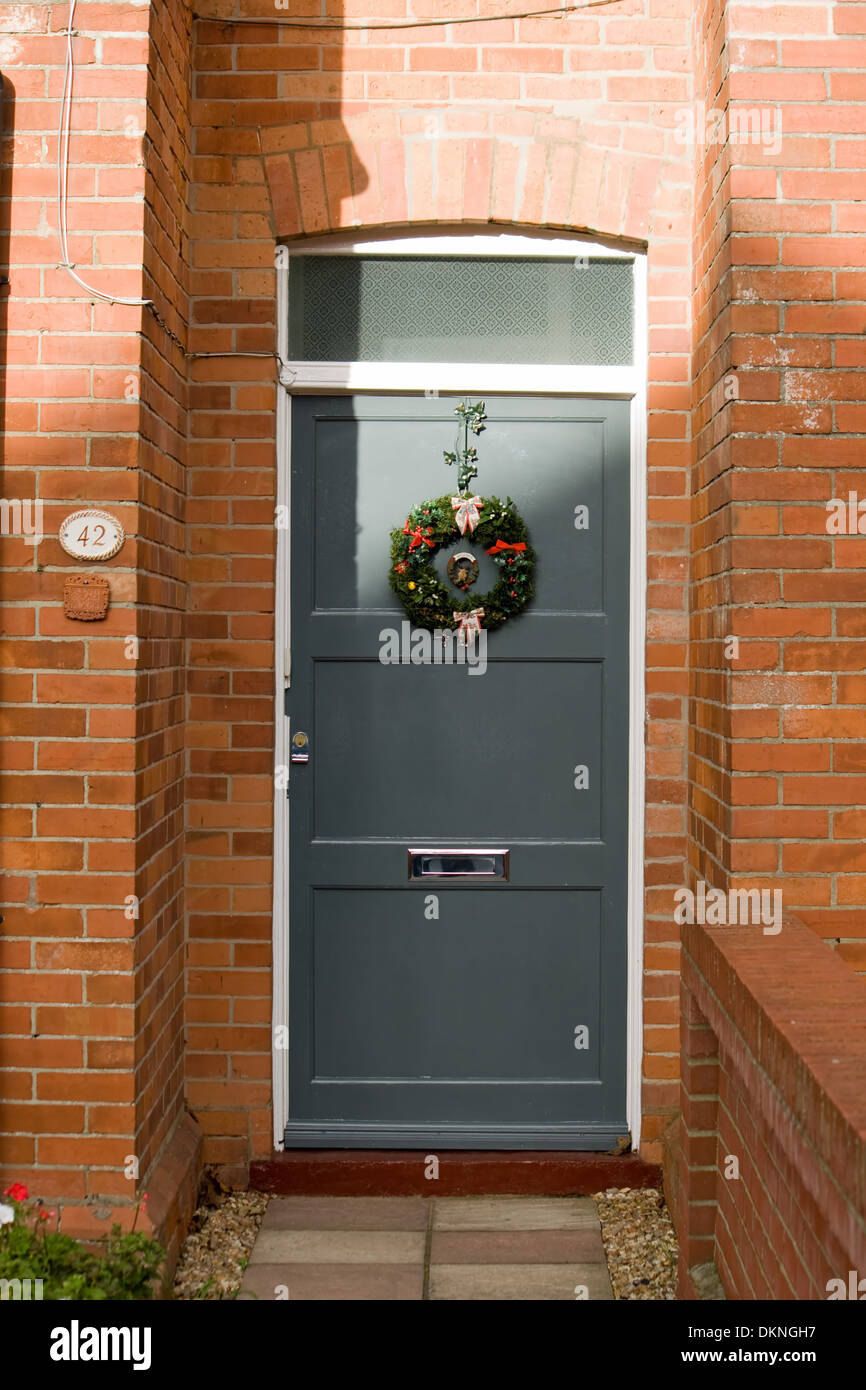 Christmas wreath on a newly painted front door. Stock Photo