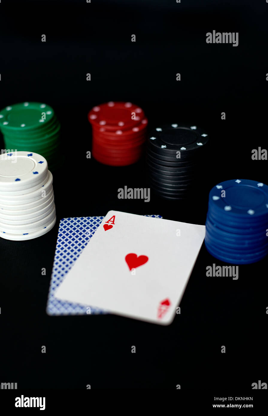 Playing cards and poker chips on a black background set up for a game of 21 or pontoon Stock Photo