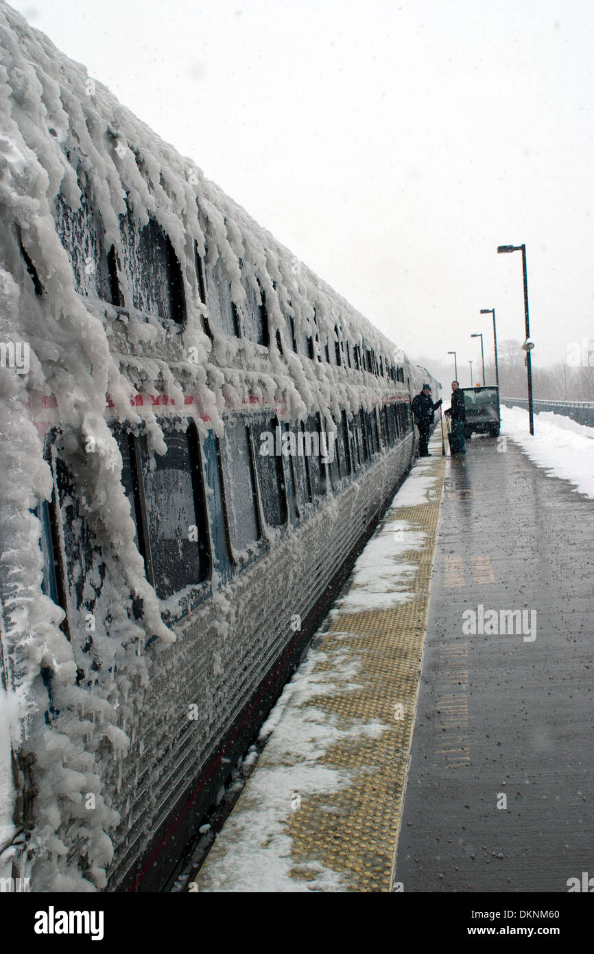 Amtrak passenger sleeper car on a stormy winter day, pausing at a station. Stock Photo
