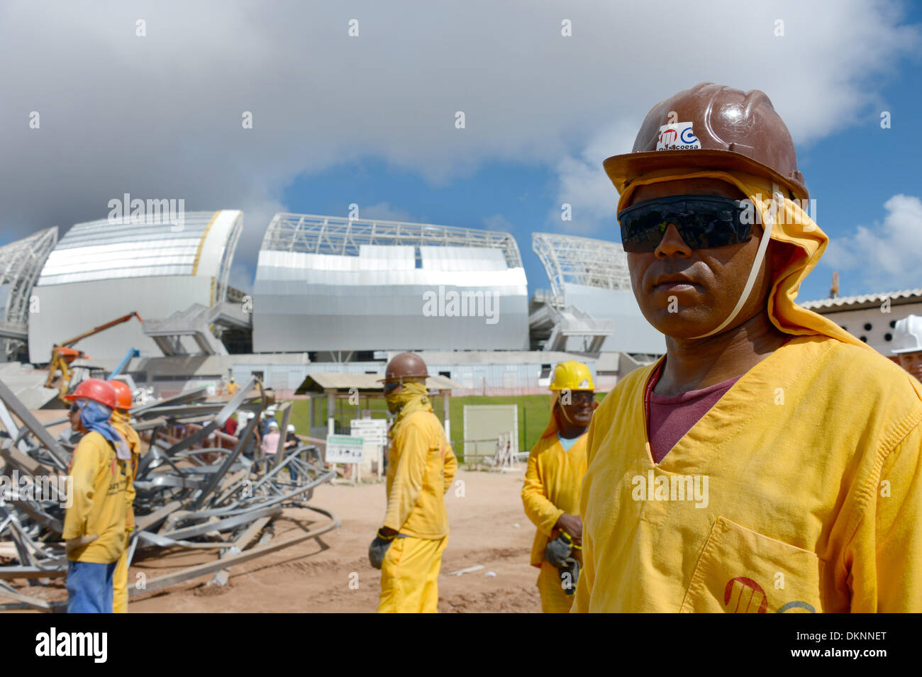 Natal, Brazil. 8th Dec, 2013. Construction workers stand on the construction site of the 'Arena das Dunas' stadium in Natal, Brazil, 8 December 2013. Photo: Marcus Brandt/dpa/Alamy Live News Stock Photo