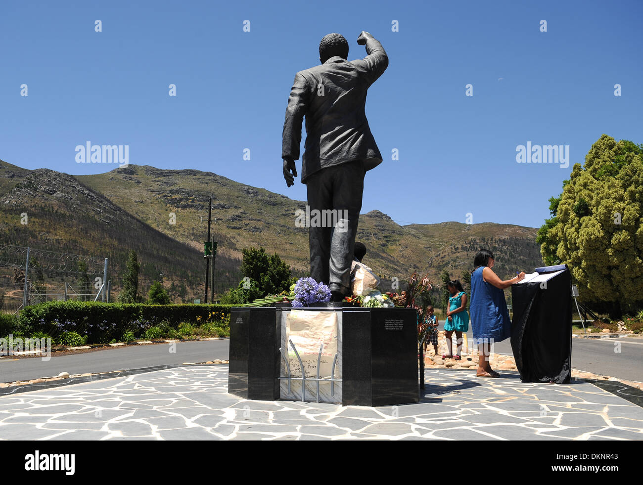 Paarl, South Africa. 8th Dec 2013. visitors place flowers at the statue of Nelson Mandela at the entrance of the Groot Drakenstein Prison formerly known as the Victor Verster Prison in Paarl, just outside of Cape Town. The statue is at the place Nelson Mandela walked out of prison, a free man, on 11 February 1990. Photo by Roger Sedres/ImageSA Stock Photo