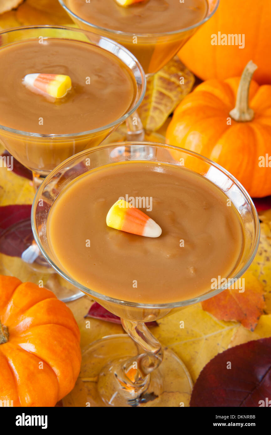 Martini glasses filled with butterscotch pudding decorated with candy