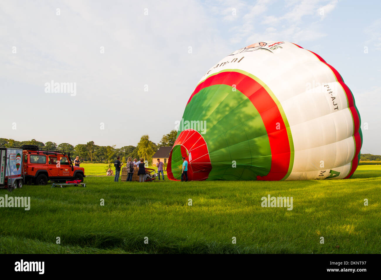 Hot air balloon being inflated before flight across countryside Stock Photo