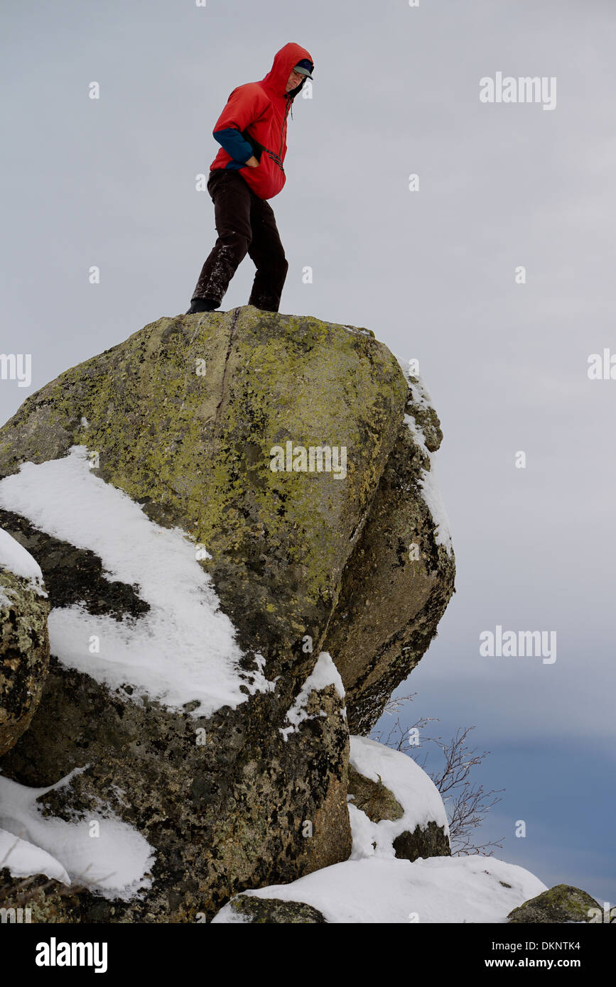 Hiker on top of a lichen covered rock at Finger Mountain along the Dalton Highway Alaska USA Stock Photo