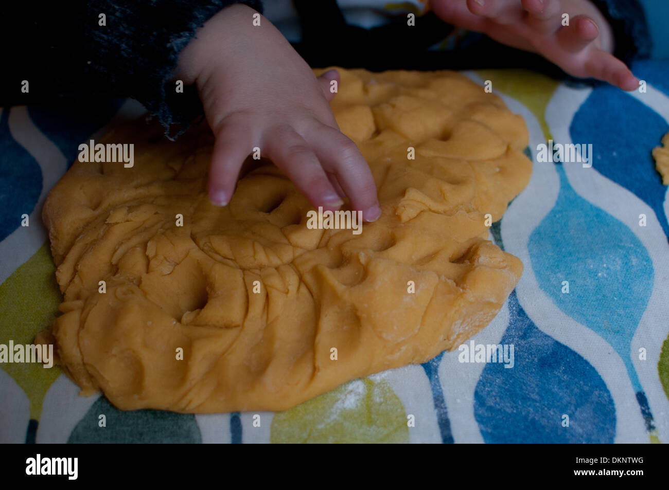 Toddler playing with home-made play dough Stock Photo
