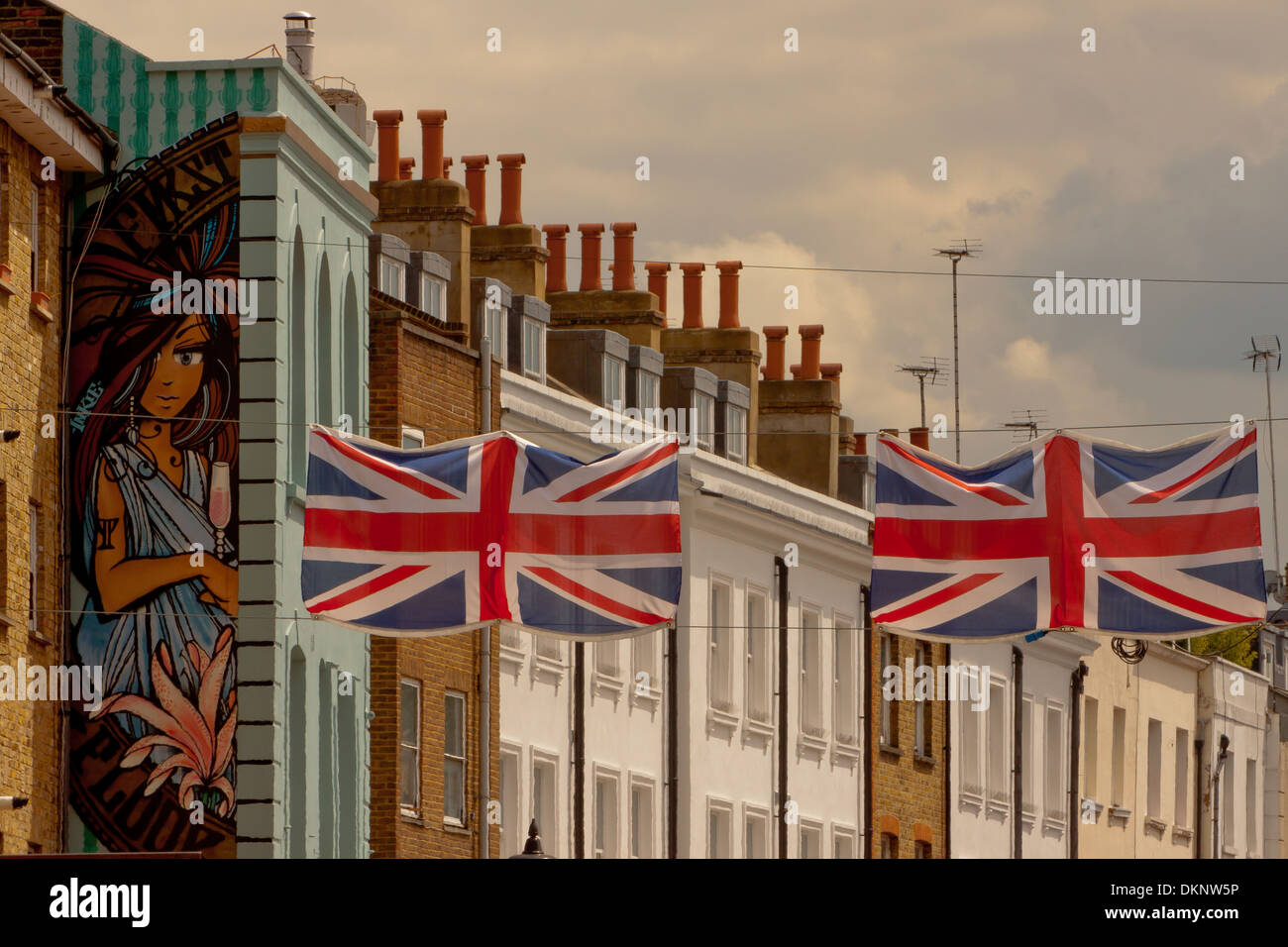 A mural and Union Jacks fly over Portobello Road Street Market in