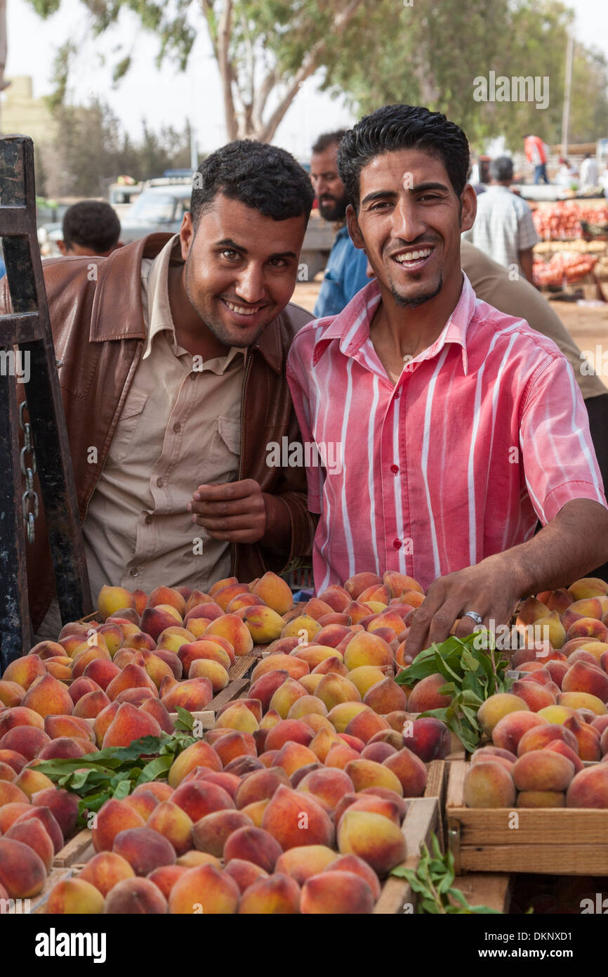 Libya, Tripoli. Two Libyans Selling Peaches at a Roadside Fruit and