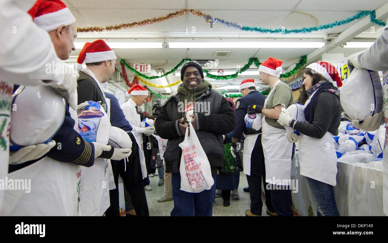 Toronto, Canada. 8th Dec, 2013. A man(C) receives a free frozen turkey at a local store Honest Ed's during the 26th pre-Christmas turkey giveaway event in Toronto, Canada, Dec. 8, 2013. Hundreds People around the city lined up to get 1,500 free frozen turkeys and fruit cakes in this annual event on Sunday. Credit:  Zou Zheng/Xinhua/Alamy Live News Stock Photo