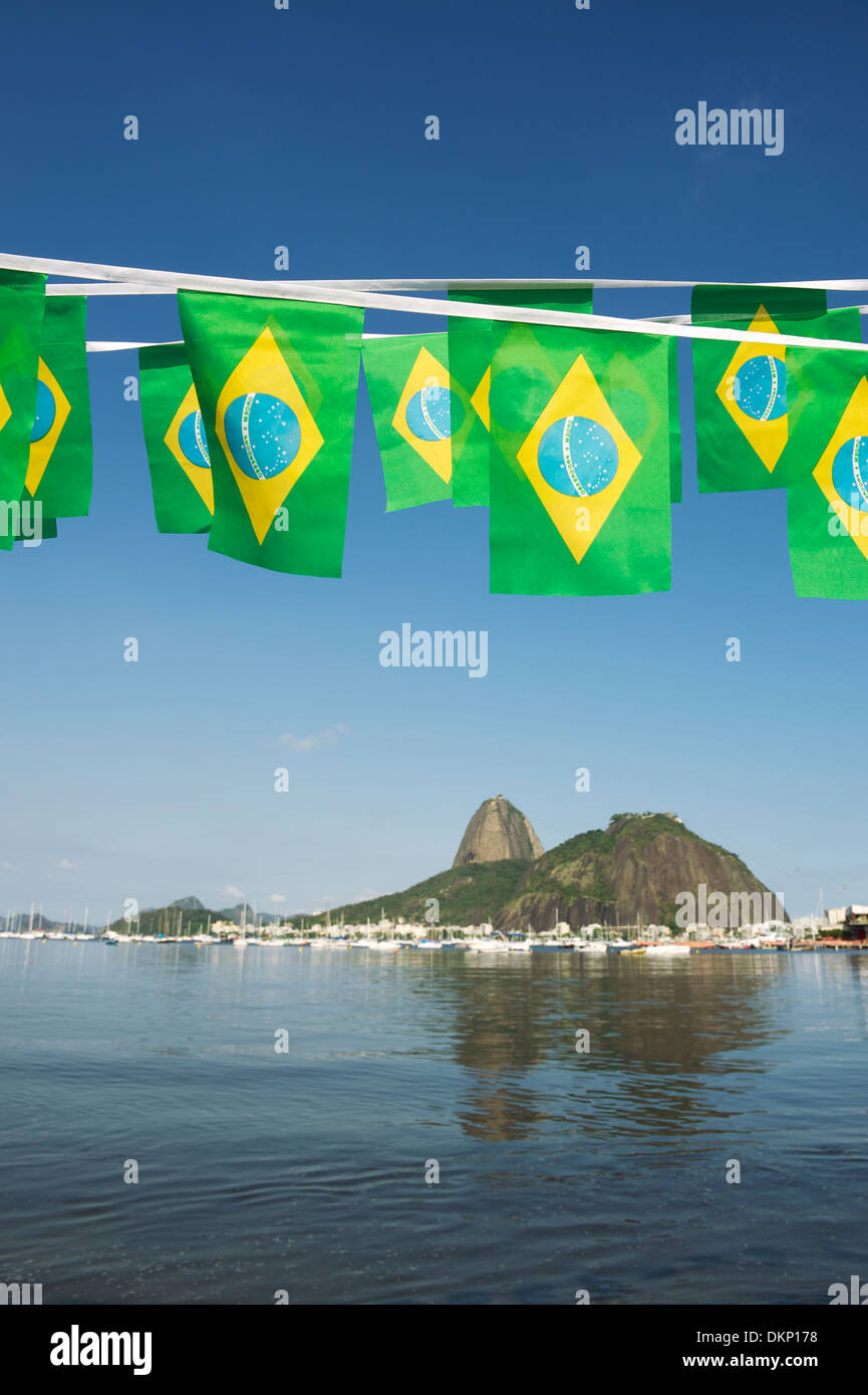 Brazilian flags bunting decoration above Sugarloaf Pao de Acucar Mountain Rio de Janeiro scenic sea view Brazil Stock Photo