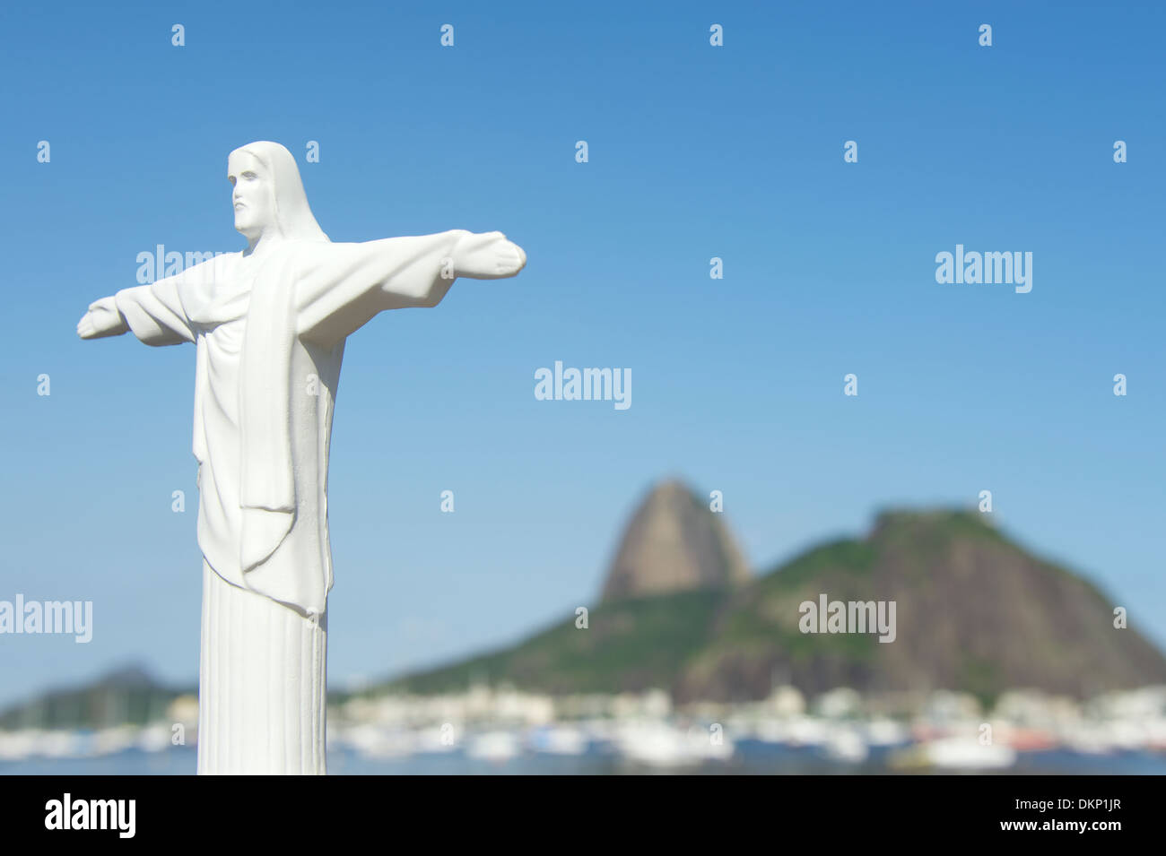 Rio Christ the Redeemer replica stands over Sugarloaf Mountain Pao de Acucar Stock Photo
