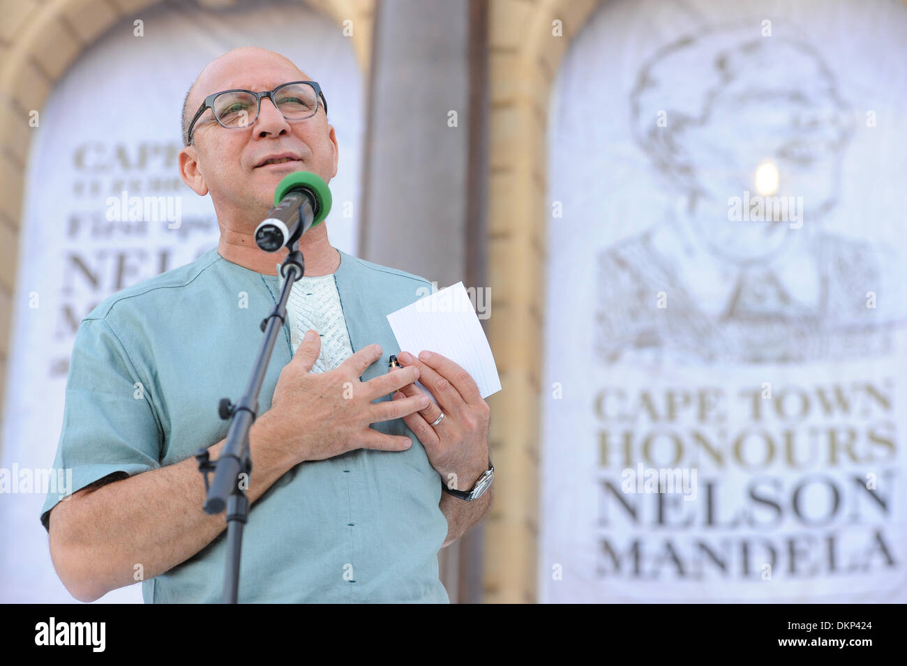 Cape Town, South Africa. 8th Dec, 2013. Minister in the Presidency, TREVOR MANUEL, addresses the crowd. The City of Cape Town hosted an interfaith service on the Grand Parade as the day was declared a national day of prayer and reflection on the life of Nelson Mandela. Visitors also placed flowers and condolence messages on the barricade erected to accommodate it. Various religious leaders said prayers for the late South African President. Photo by Roger Sedres/ImageSA Stock Photo