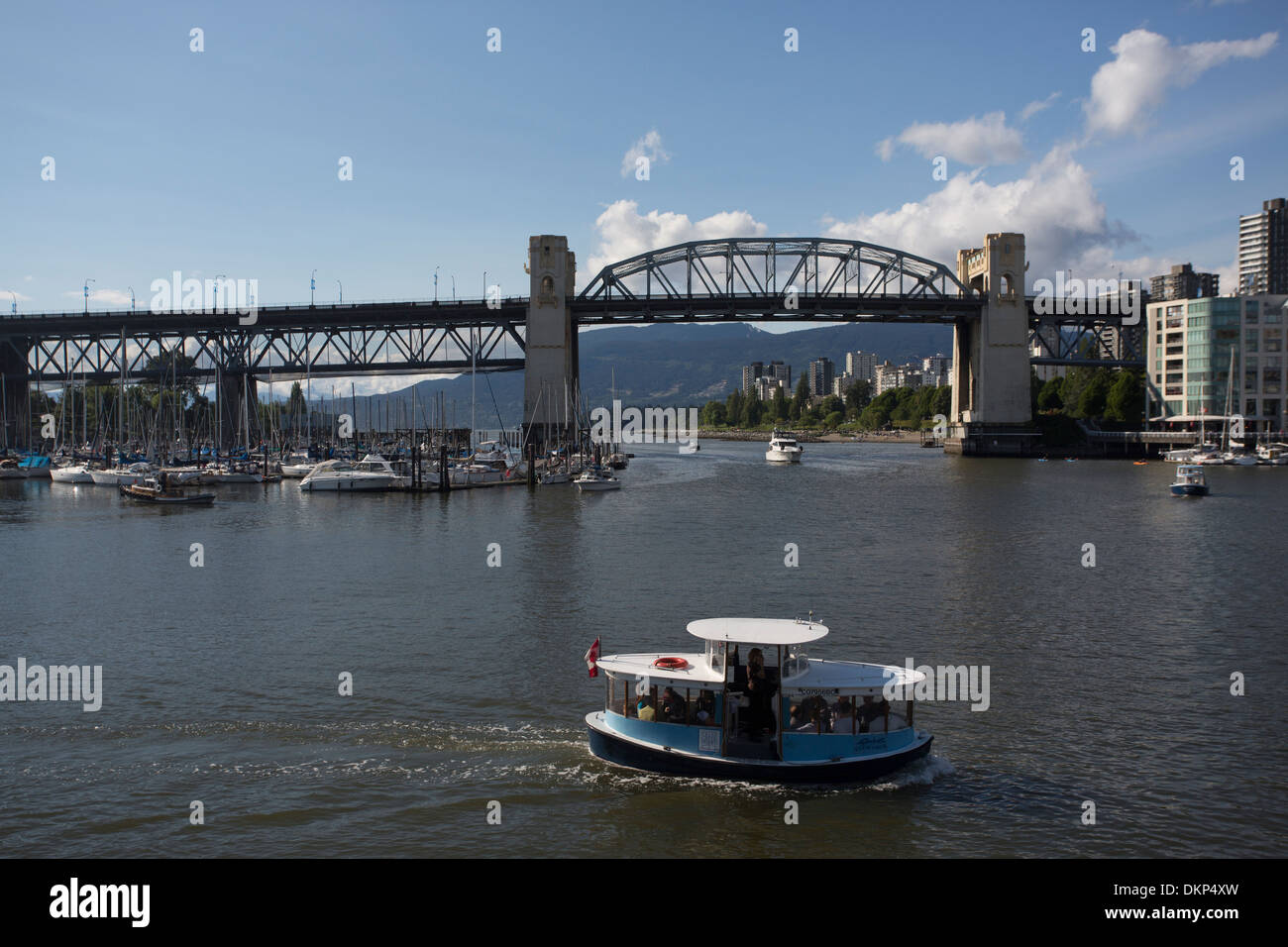 Burrard Bridge in Vancouver, BC, with ferry in the foreground. Stock Photo
