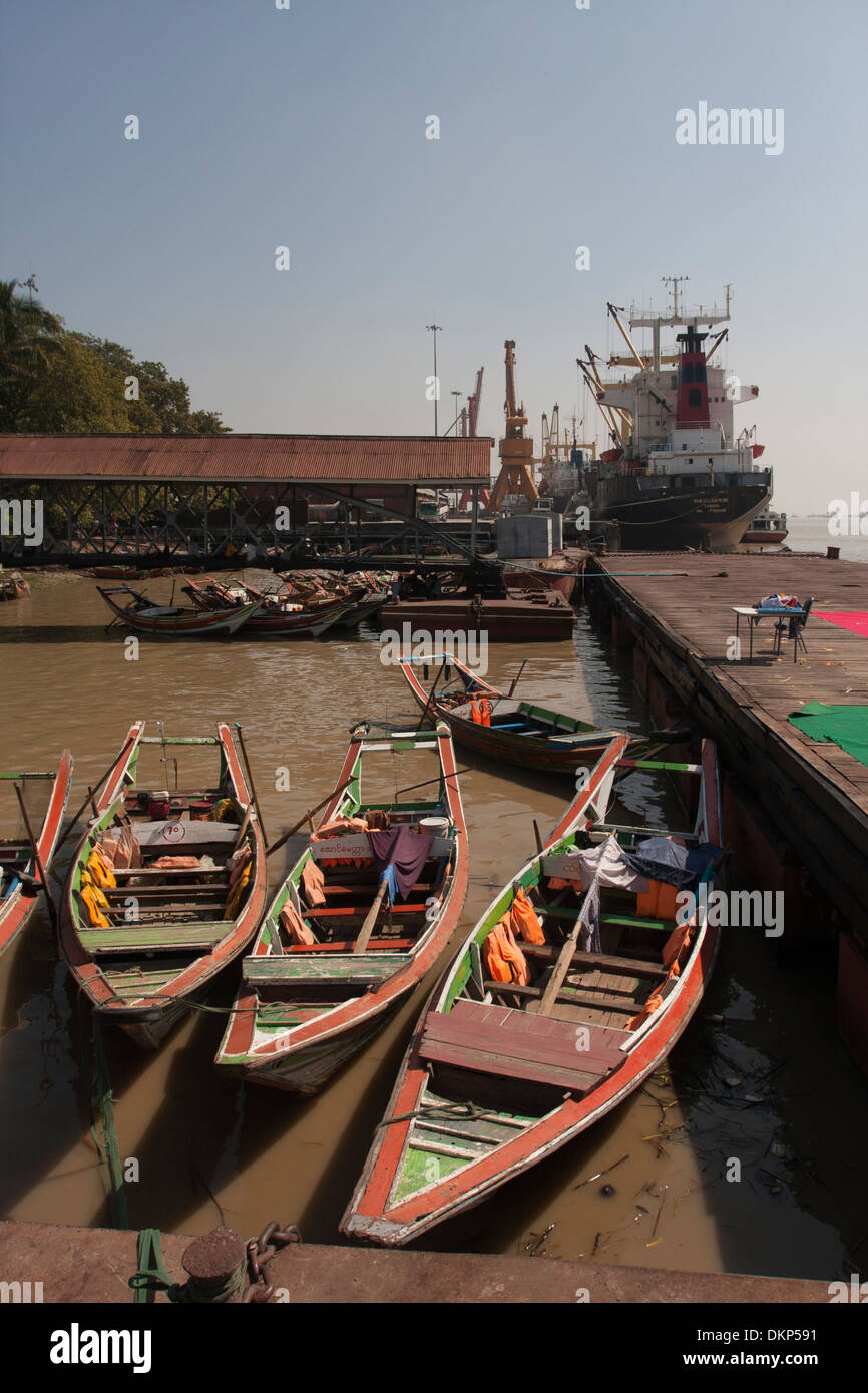 Three traditional boats in Yangon, Myanmar. Stock Photo