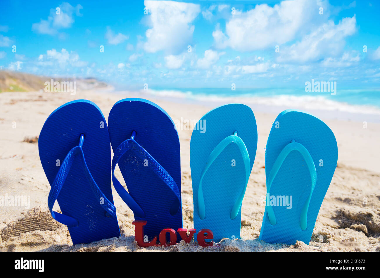 Flip flops with sign "Love" on the sandy beach by the ocean Stock Photo ...