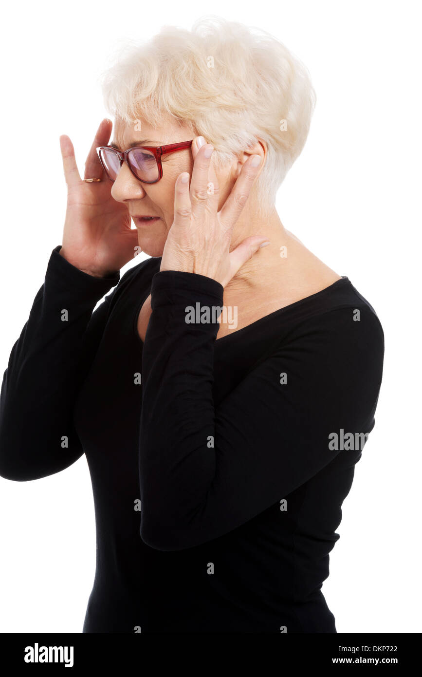 An old woman is eye glasses is having a headache. Isolated on white