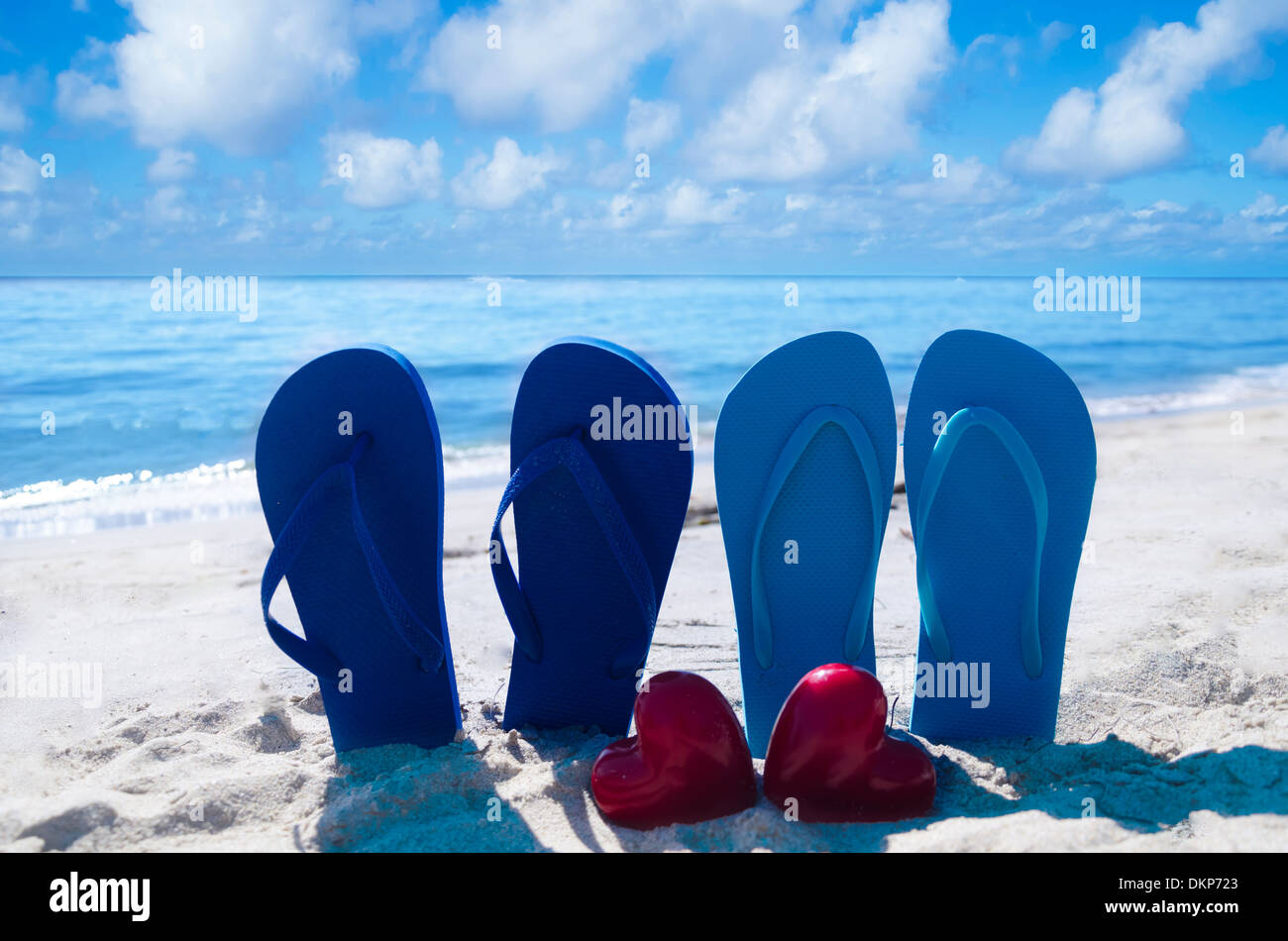 Flip flops with two heart shapes on the sandy beach by the ocean Stock ...