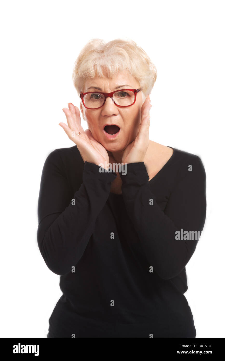 An old lady expresses shock/ surprise. Isolated on white.  Stock Photo