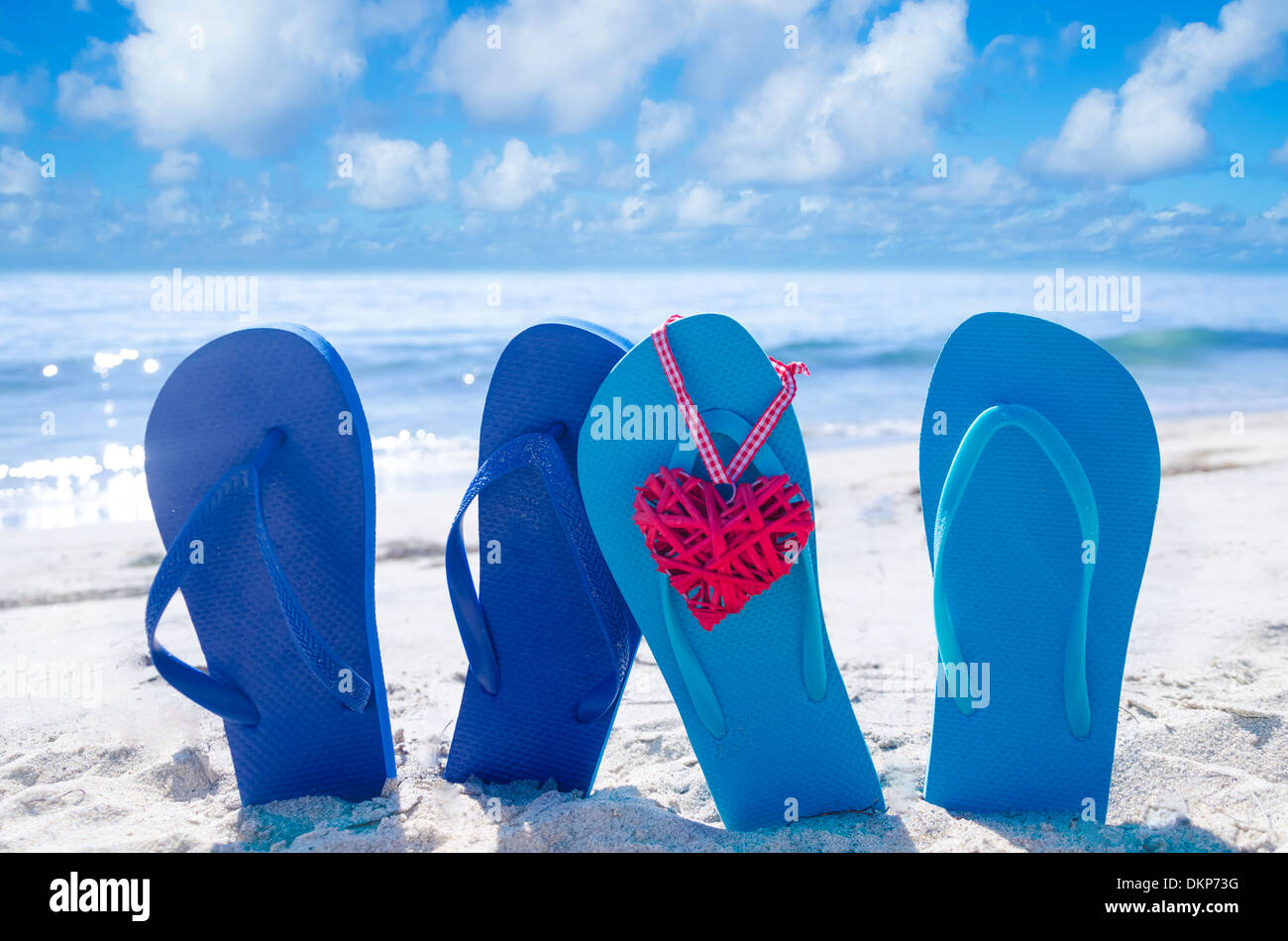 Flip flops with heart shape on the sandy beach by the ocean Stock Photo ...