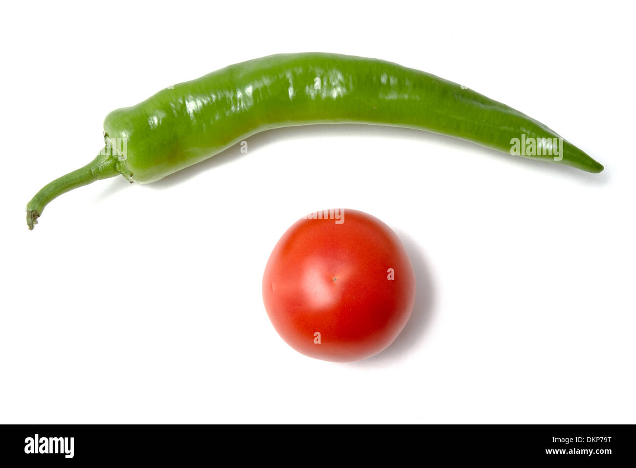 Red tomato and green pepper closeup on white background Stock Photo