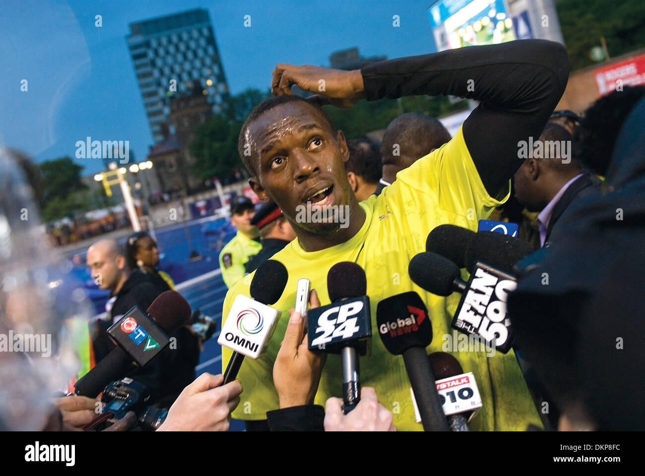 June 11, 2009 - Toronto, Ontario, Canada - 11 June 2009:  World record holder and three-time Olympic gold medalist Usain Bolt performs his talent in front of a sold-out audience of approximately 5000 fans at the University of Toronto's Festival of Excellence at the Varsity Centre. Despite rain, a wet track , and a -0.9 head wind, Usain still managed to sprint a time of ten seconds  Stock Photo