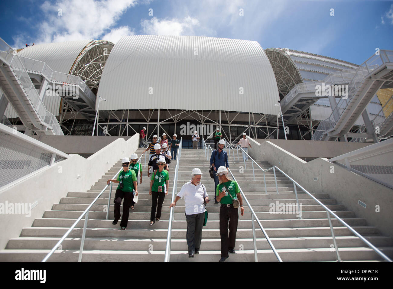 Natal, Brazil. 9th Dec, 2013. People walk out of Arena das Dunas in Natal, Rio Grande do Norte, Brazil, Dec. 8, 2013. Arena das Dunas, which is scheduled to finish the reformation on Jan. 14, 2013, will hold four group matchs during the 2014 World Cup. © Xu Zijian/Xinhua/Alamy Live News Stock Photo