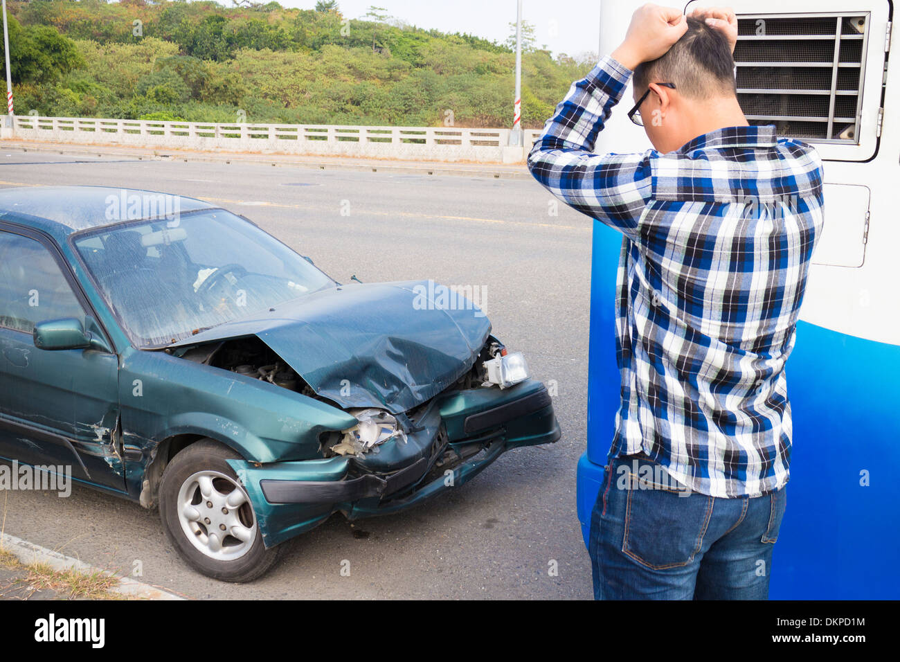 Stressed Driver looking the car After Traffic Accident Stock Photo
