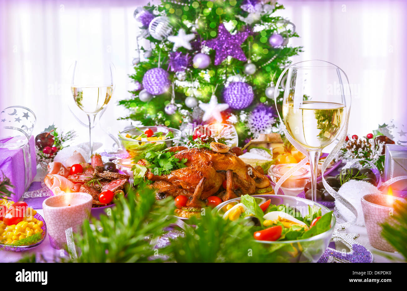 Christmastime dinner with backed chicken, various of dish and traditional Christmas drink, champagne, New Year eve concept Stock Photo