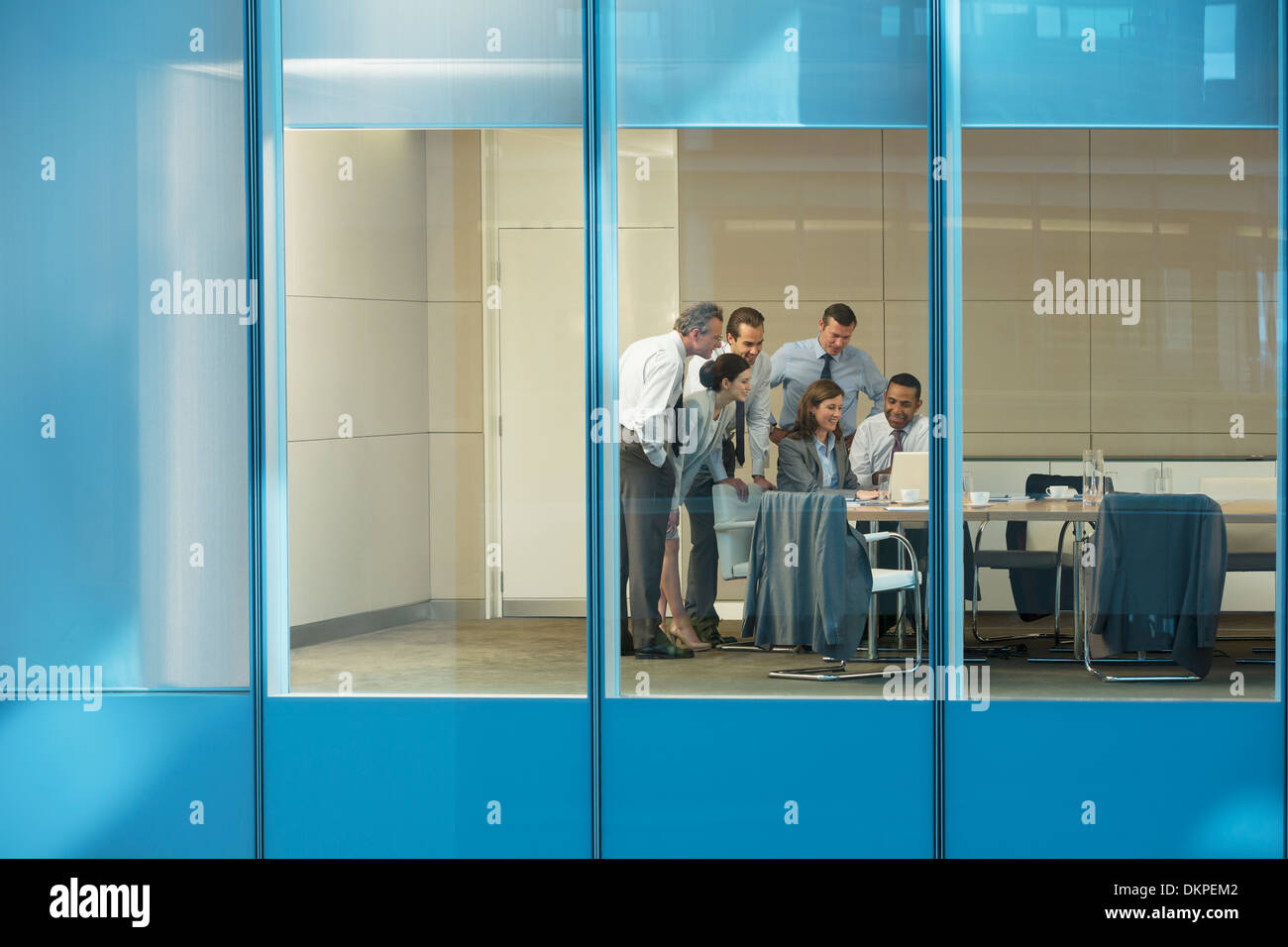 Business people using laptop in conference room Stock Photo