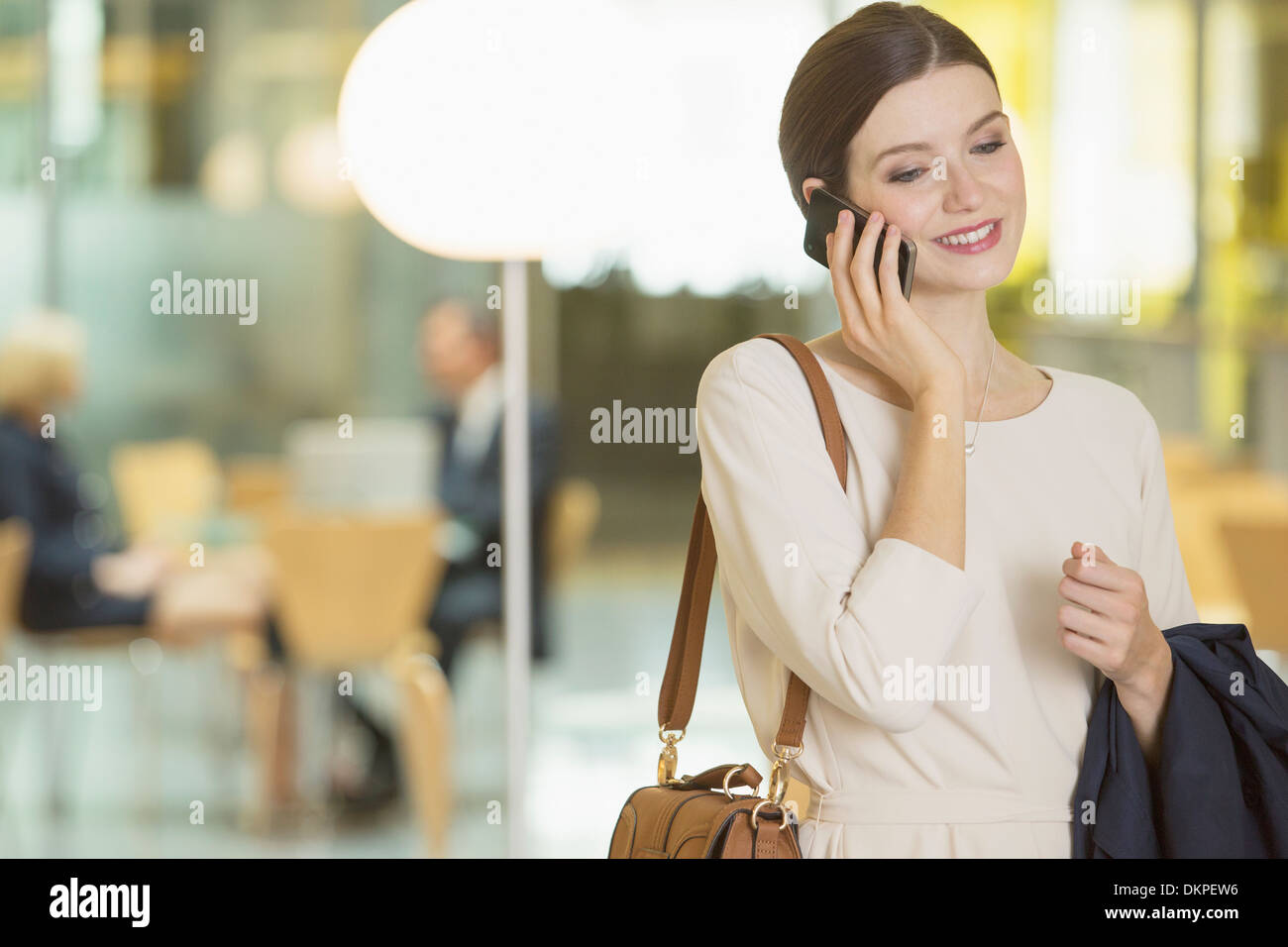 Businesswoman talking on cell phone in office Stock Photo