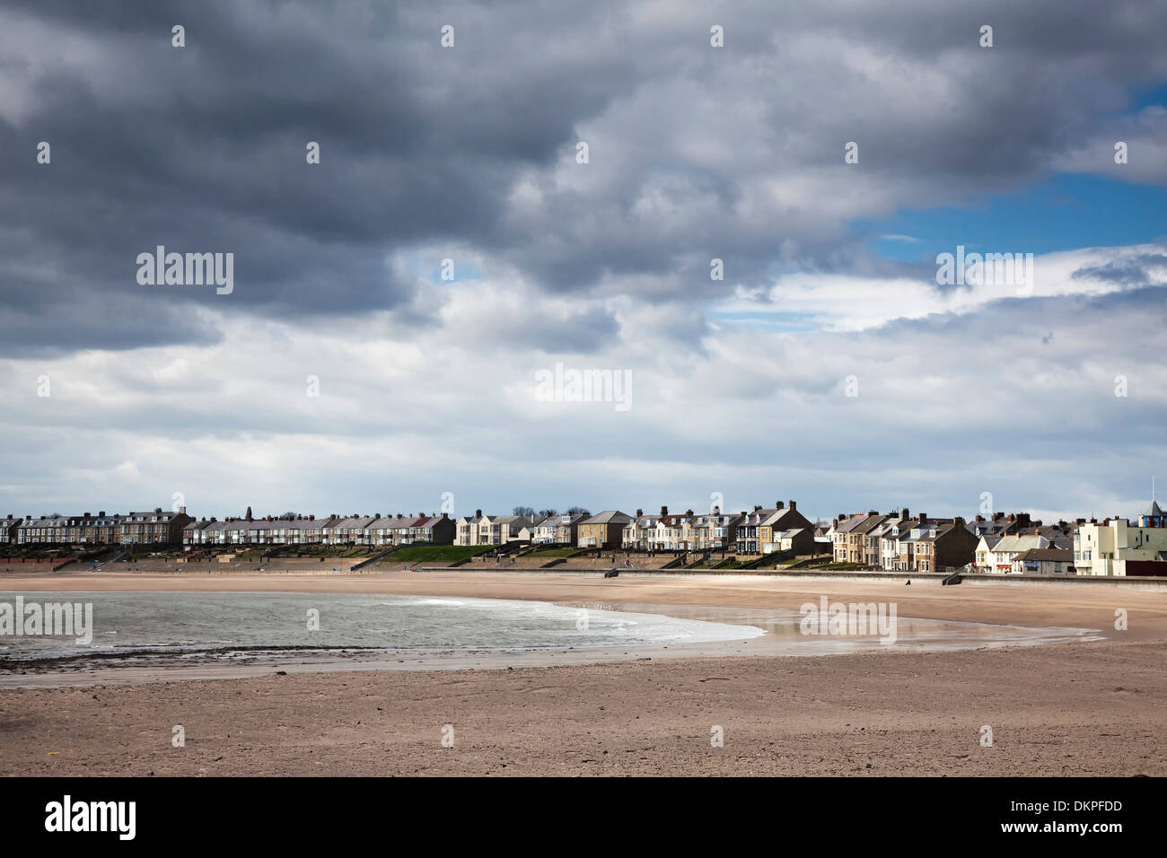 Clouds forming over coastal village Stock Photo