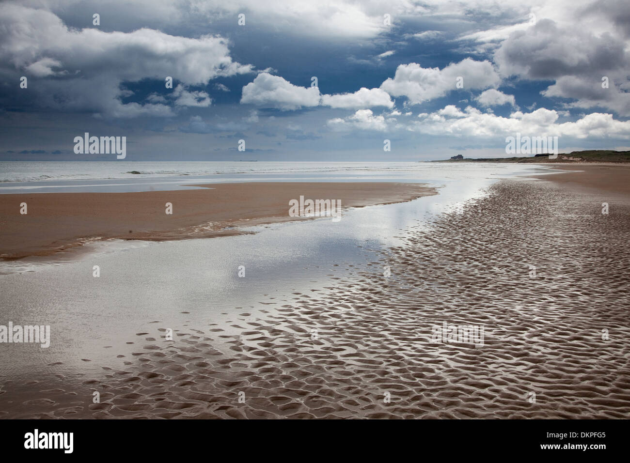 Clouds over beach at low tide Stock Photo
