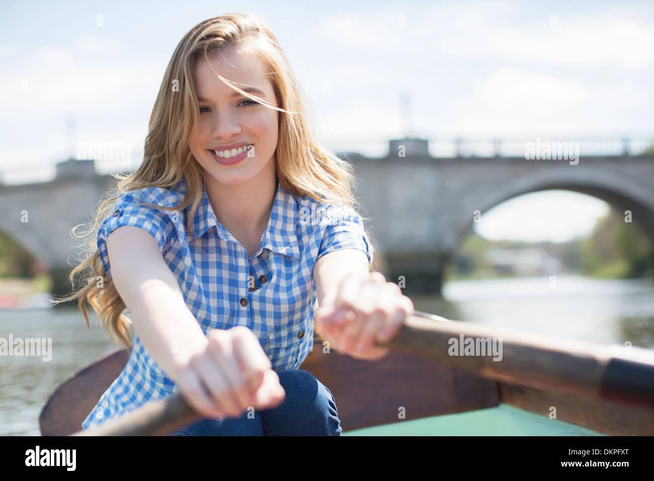 Woman rowing boat on river Stock Photo