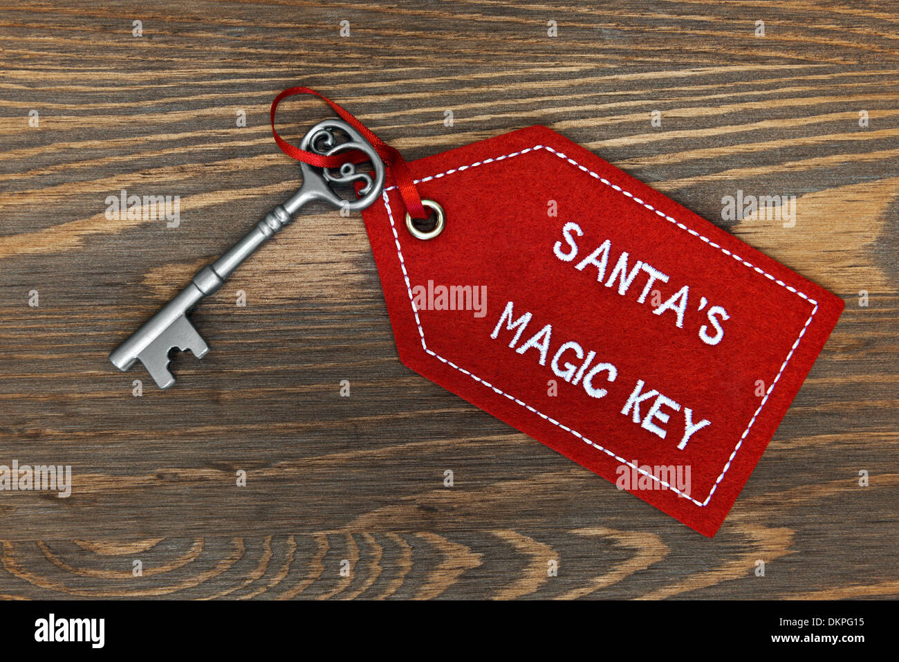 Santa's magic key on a rustic wooden background. Stock Photo