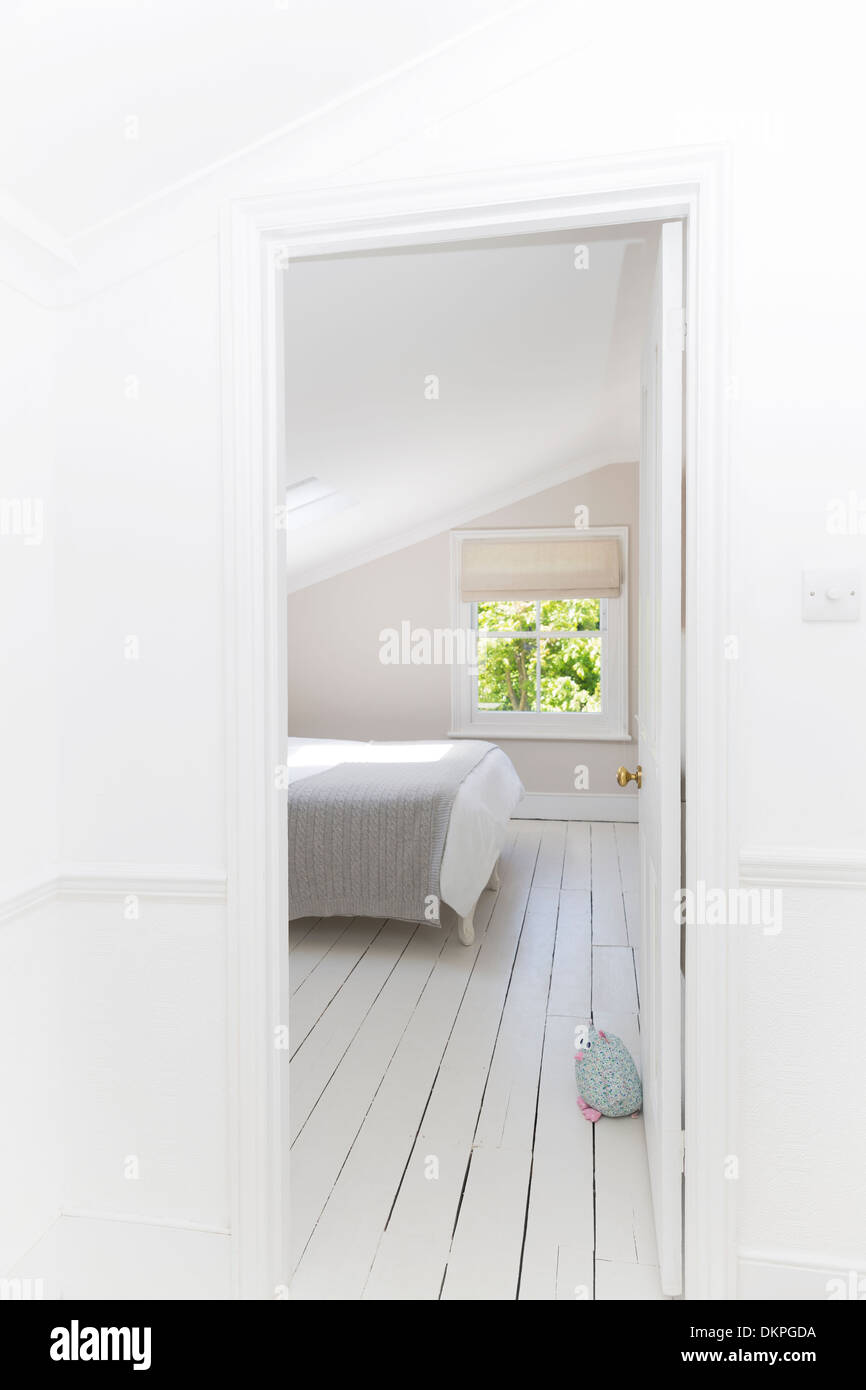 Doorway to whitewashed bedroom Stock Photo