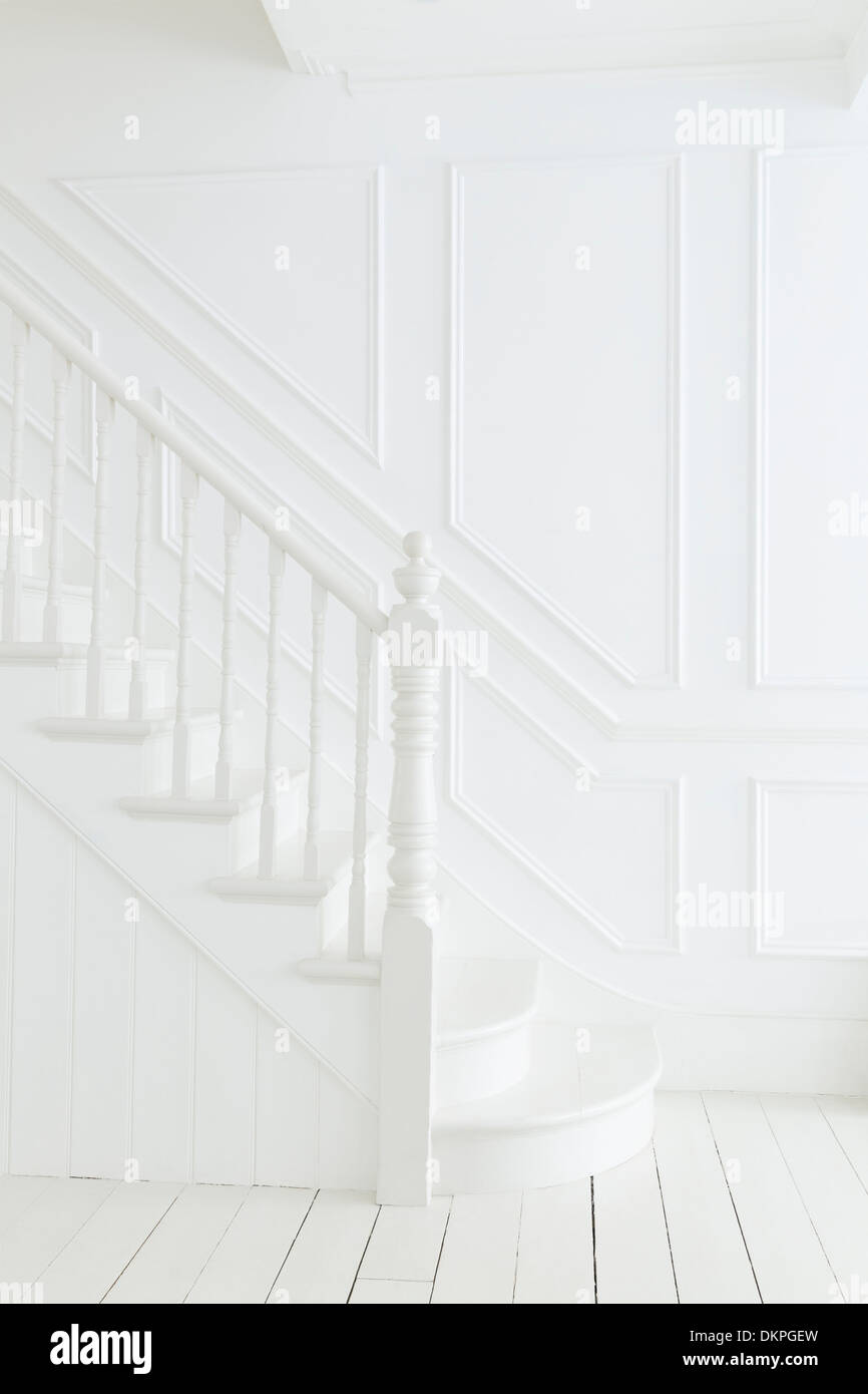 Banister and staircase in white foyer Stock Photo
