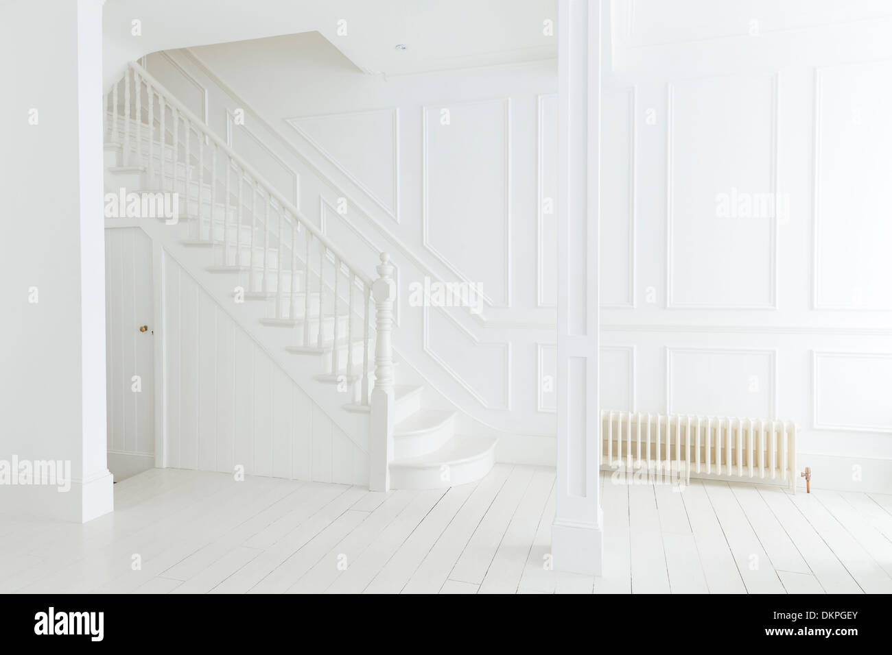 White staircase and walls in ornate house Stock Photo