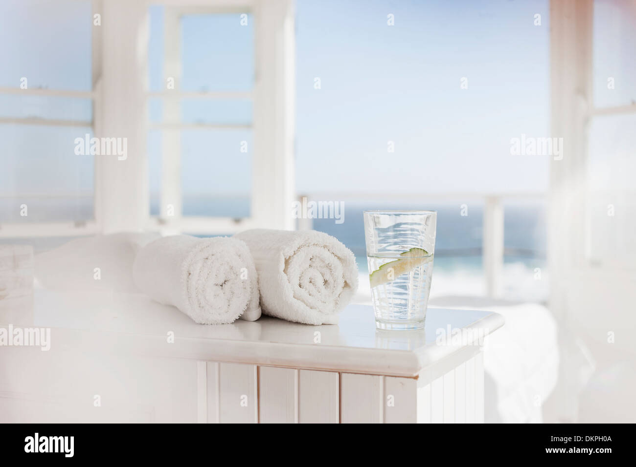 Glass of water and towels on table Stock Photo