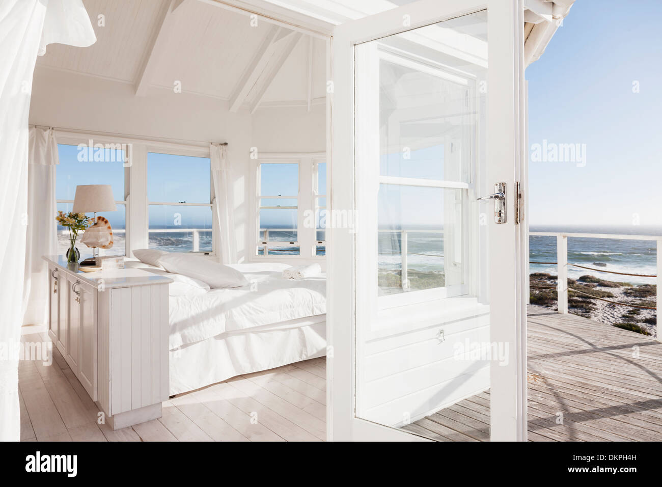 White bedroom overlooking ocean Stock Photo Alamy